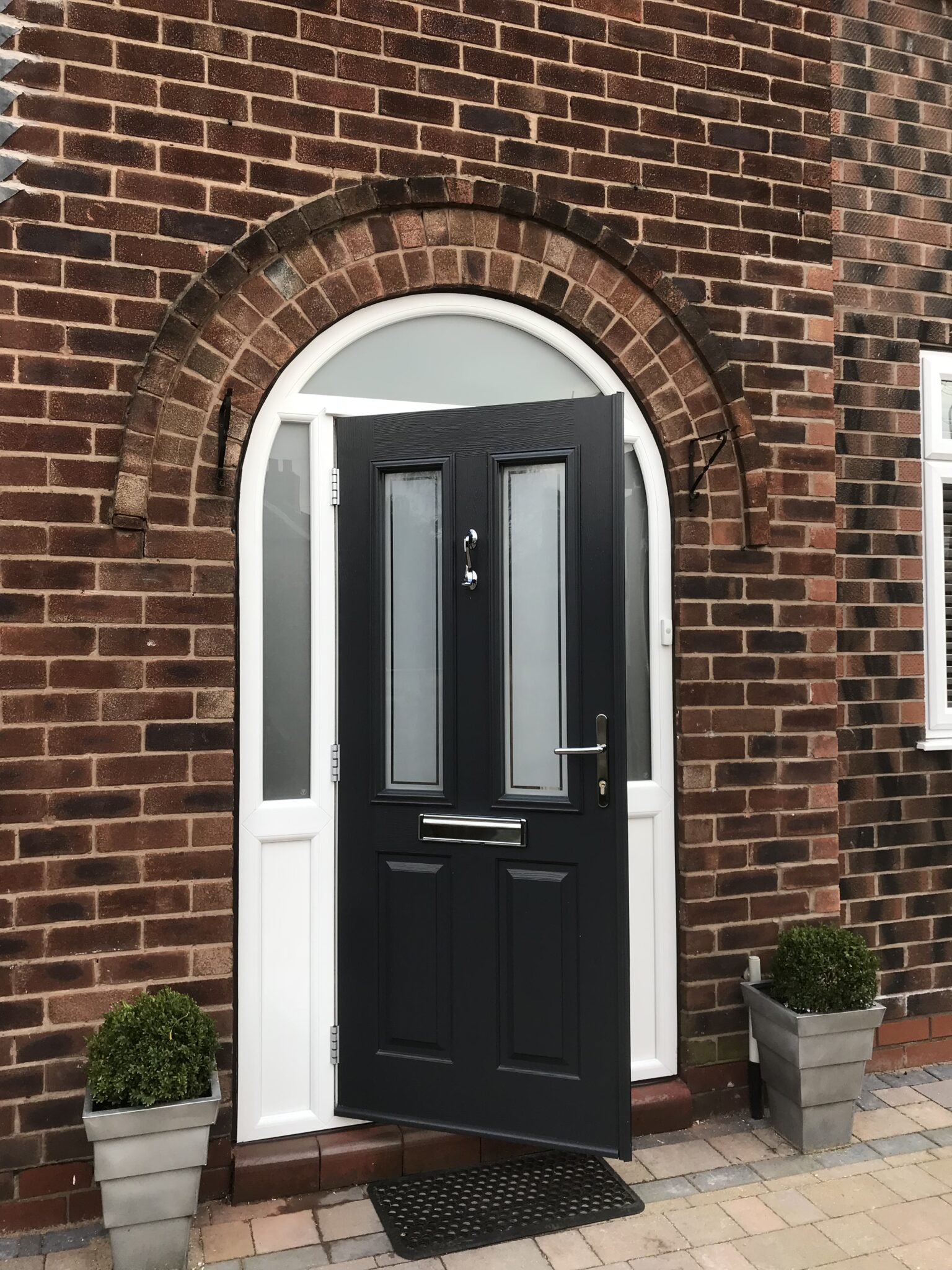 A black door with a white frame and glass, showcasing a modern and elegant design.