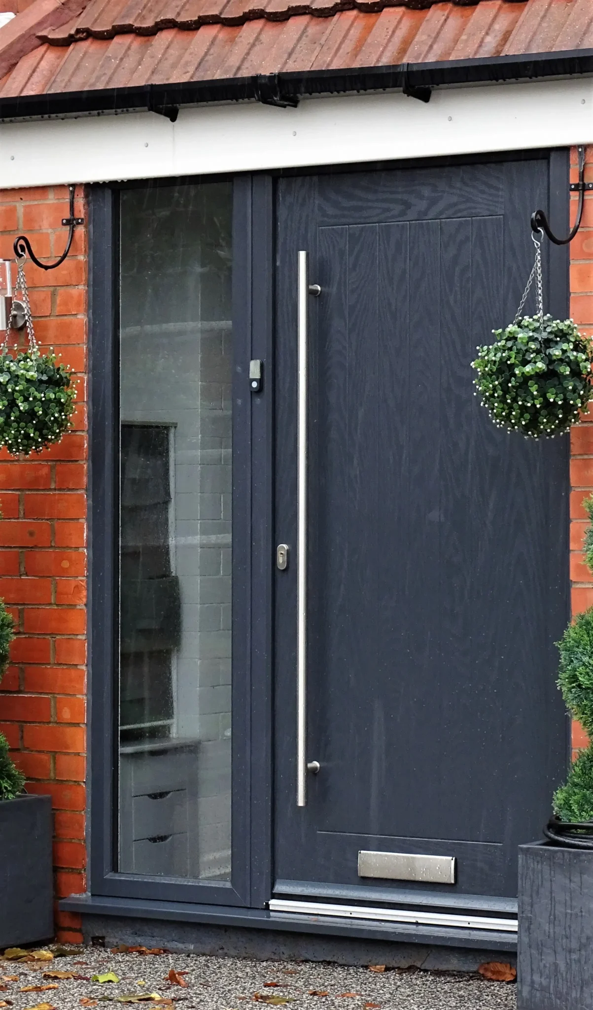 a black front door with a full glass beside