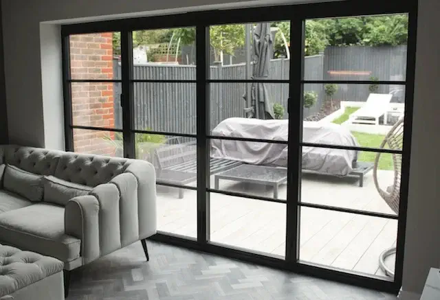 a black bi-fold, glass doors in a patio